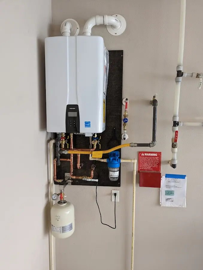 Professional plumber installing copper piping in a Glenville home